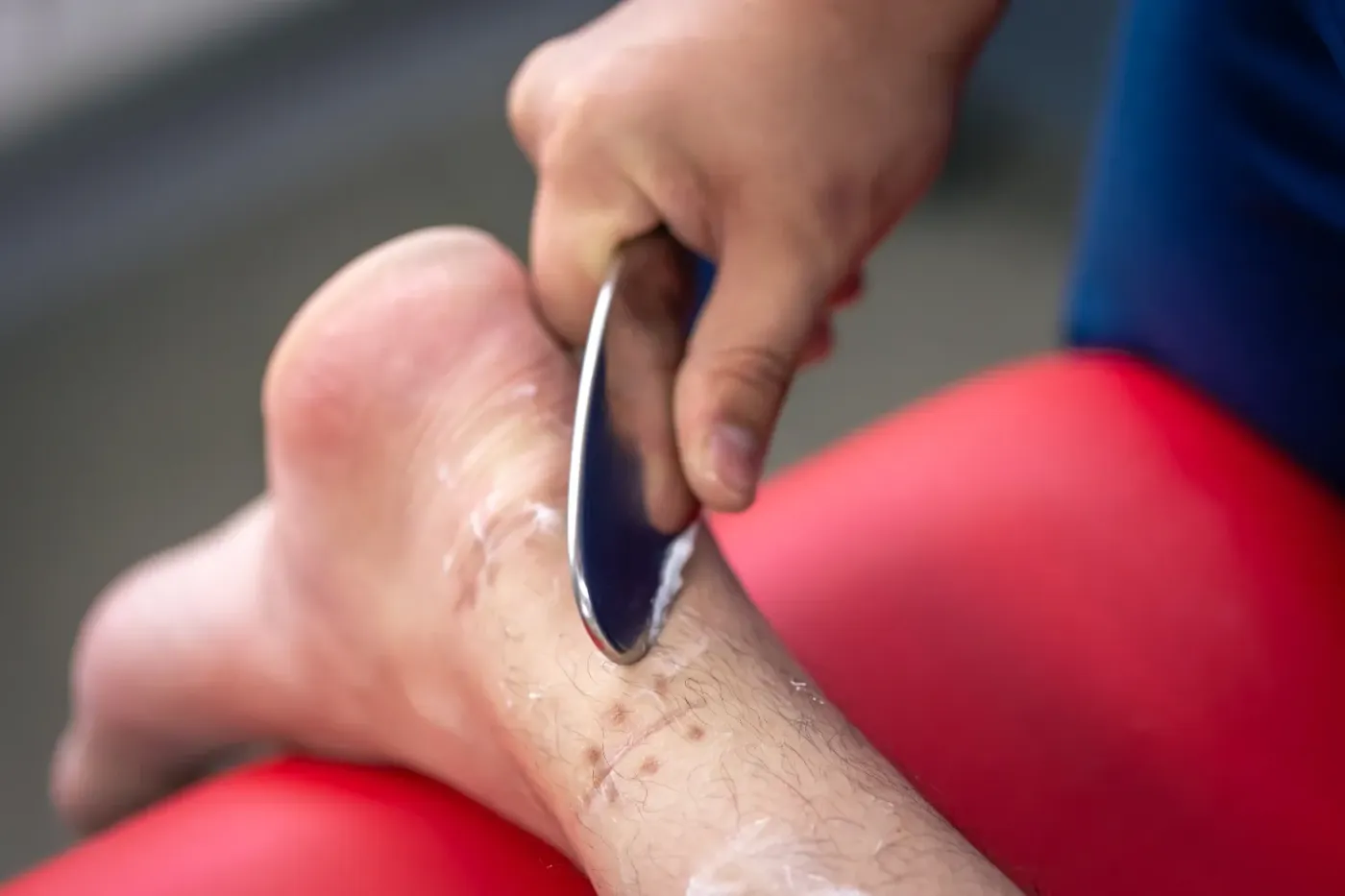 Therapist using an IASTM instrument on a patient in Abilene, KS