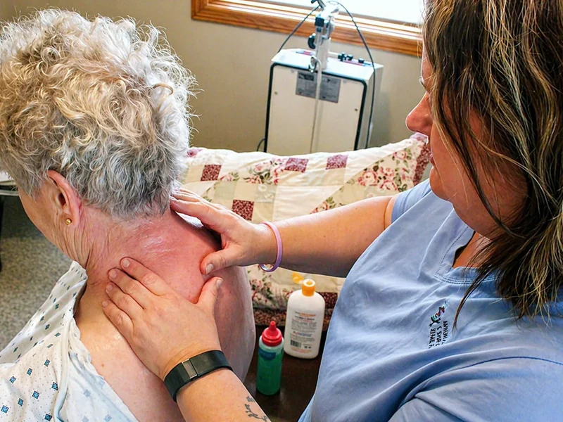 Physical therapist assessing a patient's lower back and spine