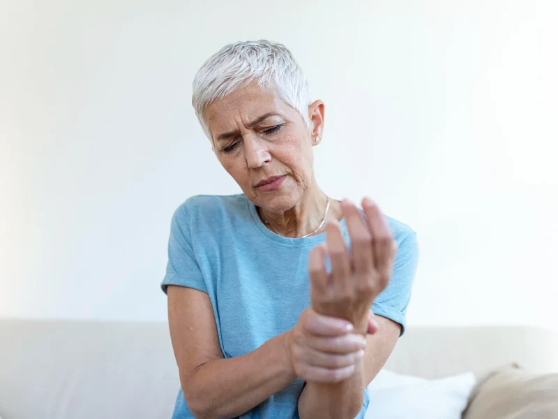 Physical therapist examining a patient's wrist and arm