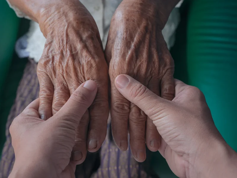 Physical therapist guiding a patient with Parkinson's through large amplitude movement