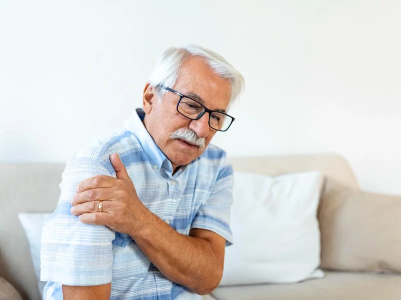 Physical therapist examining a patient's shoulder and rotator cuff