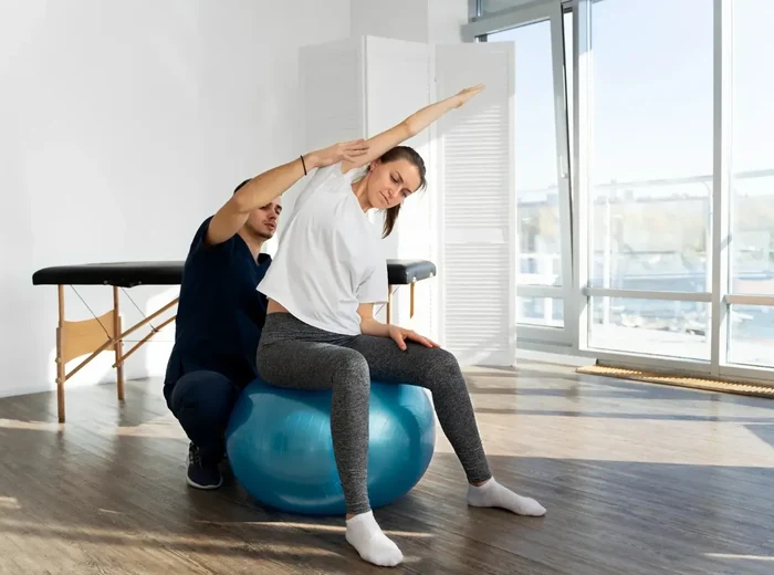 Older adult practising balance training with a therapist