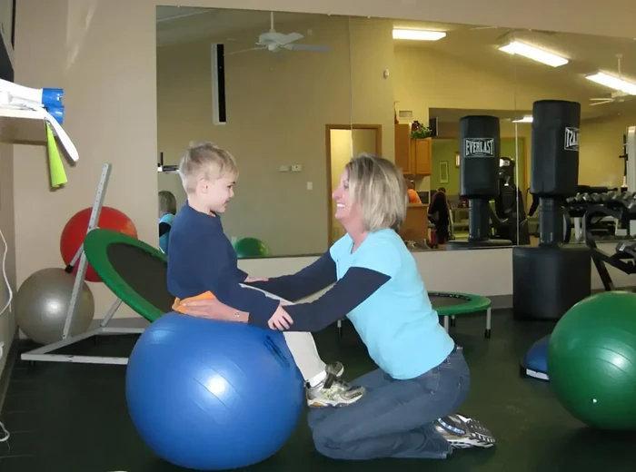 Child working through play-based physical therapy exercises